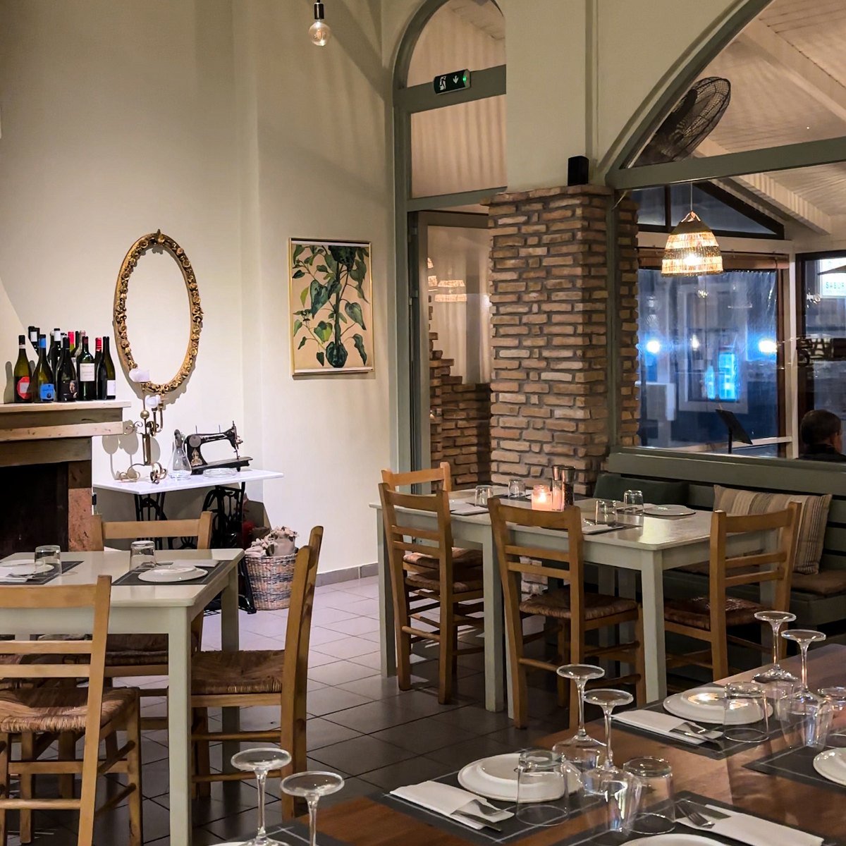 The dining room laid for the evening, candles lit under the arch